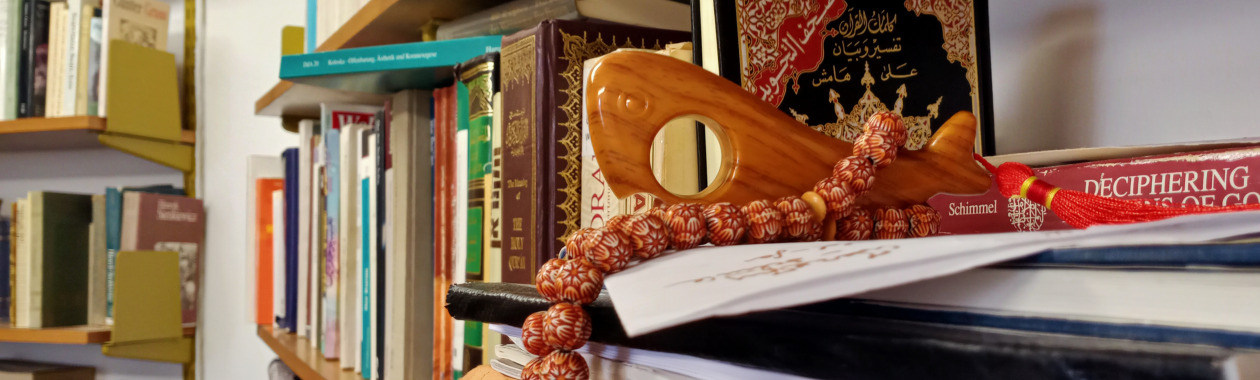 Shelf with books and Islamic religious objects  